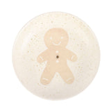 Round ceramic coaster with a gingerbread man design on a white background