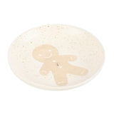 Round speckled ceramic plate with a gingerbread man design on a white background
