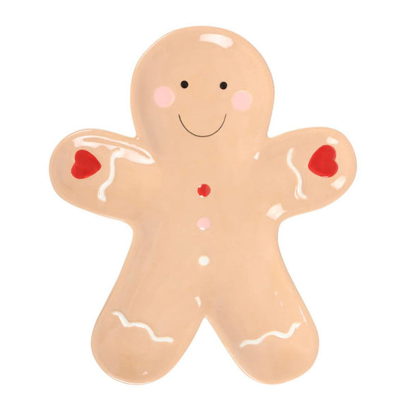 Gingerbread man-shaped cookie with red buttons on a white background