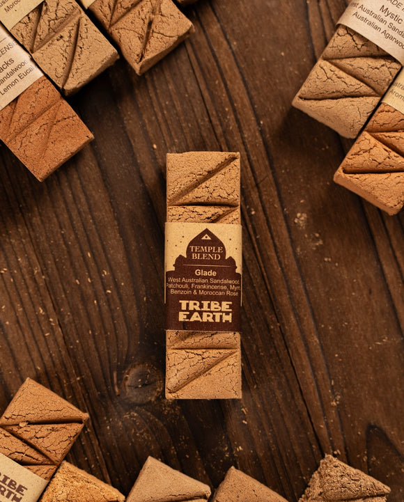 Tribe Earth chocolate bar packaging on a wooden surface with other chocolate bars.