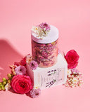 Bottle of Bopovo bath salts with flowers on a pink background