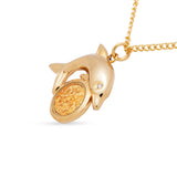 Gold dolphin pendant necklace on a white background