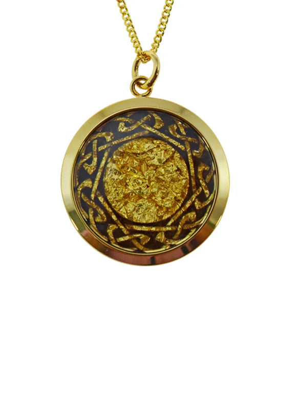 Gold necklace with a round pendant on a white background