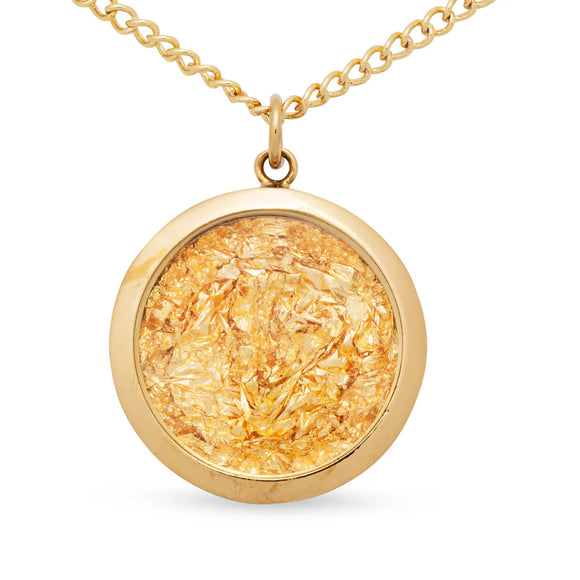 Gold necklace with a round pendant on a white background