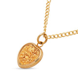 Gold necklace with a heart-shaped pendant on a white background