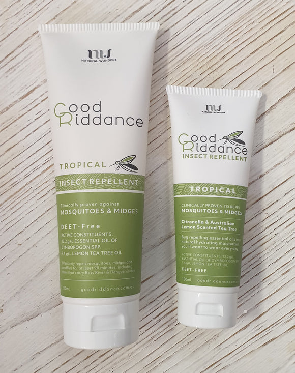 Two tubes of Good Riddance Tropical Insect Repellent, one larger and one smaller, placed side by side on a white wooden surface. The packaging is primarily white and green with text and branding.