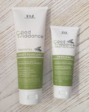 Two tubes of Good Riddance Tropical Insect Repellent, one larger and one smaller, placed side by side on a white wooden surface. The packaging is primarily white and green with text and branding.