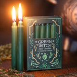 Green Witch spell candles in packaging with two lit candles on a wooden surface.