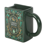Green witch-themed mug with decorative design on a white background