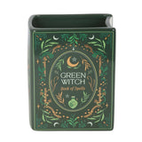 Green witch book of spells with decorative elements on a white background