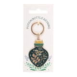 Potion bottle keyring on a white card with decorative elements