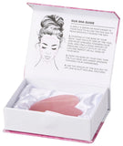 Pink gua sha tool in a white box with instructions on a white background