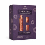 A boxed gift set from Forest & Lore's Hammered Collection, featuring a copper bottle and two copper tumblers shown through a dark purple window on the packaging.