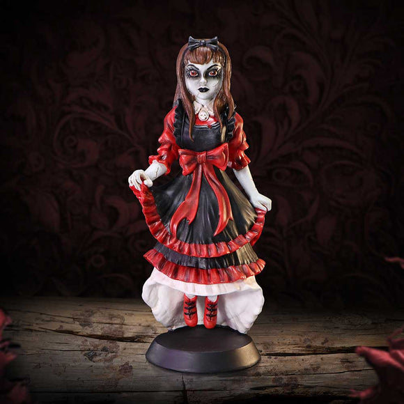 Gothic-style figurine with red and black dress on a dark background