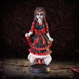 Gothic-style figurine with red and black dress on a dark background