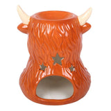 Ceramic bull-shaped candle holder with star designs on a white background