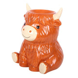 Ceramic mug shaped like a cow on a white background