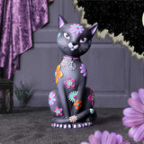 Decorative cat figurine with floral patterns on a dark background