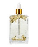 Clear bottle with floral design and gold cap on a white background