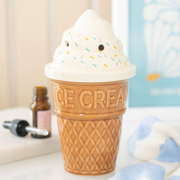 Ice cream cone-shaped oil burner with 'ICE CREAM' text on a surface.