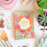 Colorful garden journal on a table with gardening items