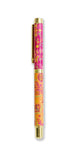 Decorative pen with pink and gold design on a white background