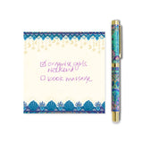 Notepad with decorative border and pen on a white background