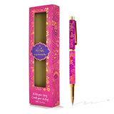 Pink pen with gold accents and decorative packaging on a white background