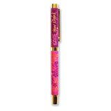 Pink pen with gold accents on a white background
