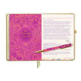 Pink journal with decorative cover and pen on a white background