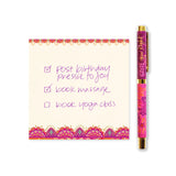 Notebook with a colorful border and a pen next to it on a white background