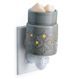 Gray decorative wax warmer with two candles on a white background