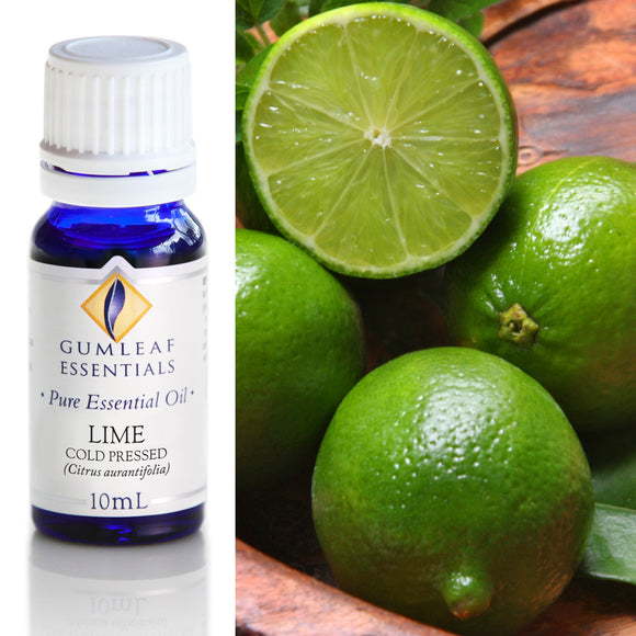 Bottle of Gumleaf Essentials Lime essential oil with fresh limes on a wooden surface