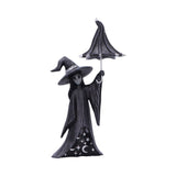 Black witch figurine with an umbrella on a white background