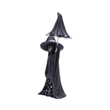 Decorative figure of a witch with a black hat and cloak on a white background