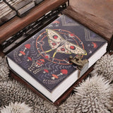 Decorative notebook with butterfly design on a textured surface