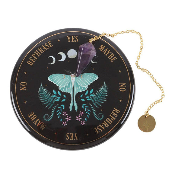 Decorative circular object with moth illustration, crystals, and gold chain on a white background