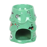 Green ceramic oil burner with Halloween-themed decorations on a white background