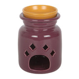 Purple ceramic oil burner with a yellow lid on a white background