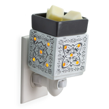 Decorative wall-mounted wax warmer with two wax melts on a white background