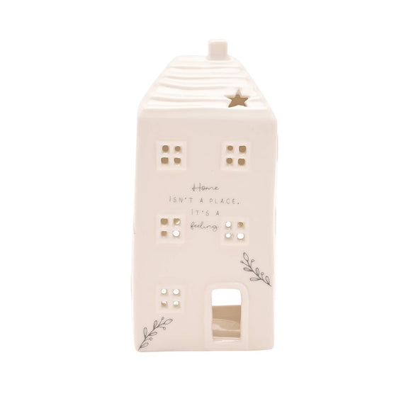 Decorative house-shaped lantern with text and star design on a white background