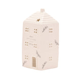 Ceramic house-shaped lantern with decorative elements on a white background