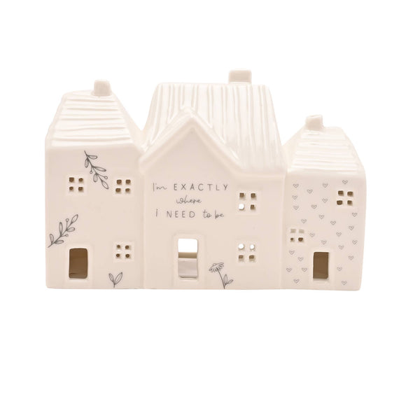 Decorative house-shaped lantern with text and patterns on a white background