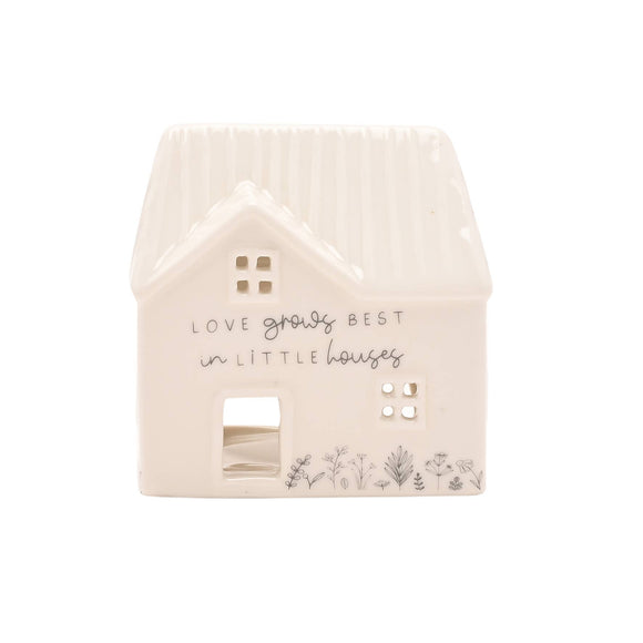 House-shaped light with 'Love grows best in little houses' text on a white background