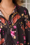 Floral blouse with colorful flowers on a blurred background
