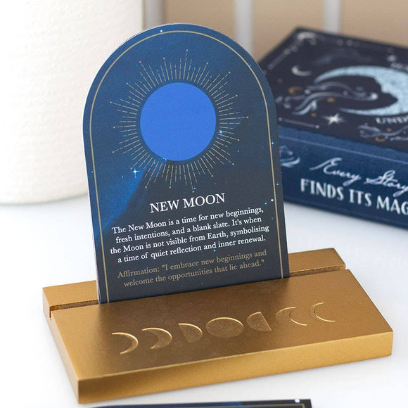 Decorative item with blue crescent moon design and gold base on a white surface