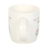 White candle with text and colorful design on a white background