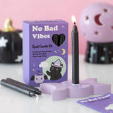 Spell candle kit with purple packaging labeled 'No Bad Vibes' on a white surface.