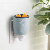 Wall-mounted diffuser with decorative design on a light background