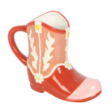 Red ceramic boot-shaped mug with white floral patterns on a white background